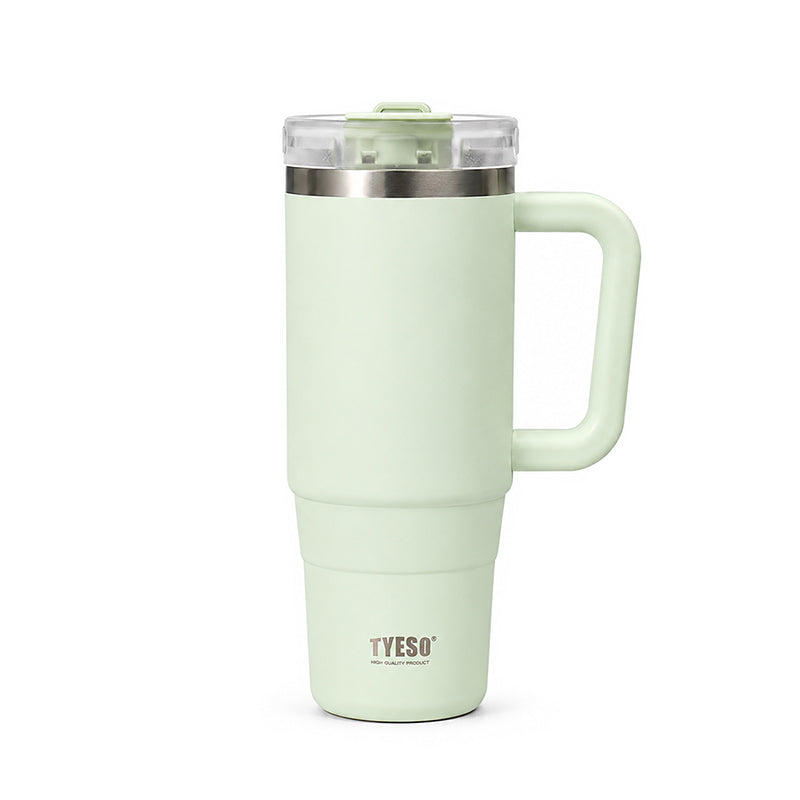 Mint green ceramic tumbler with clear lid, metal rim, and side handle