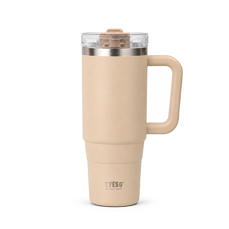 Beige ceramic tumbler with clear lid, metal rim, and side handle