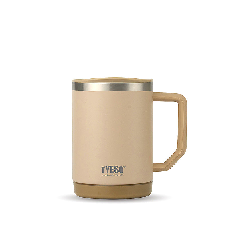 Ceramic insulated mug in tan/beige with gold-tone rim and handle, TYESO logo.
